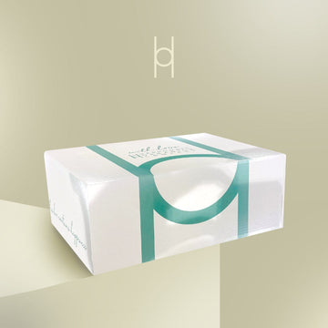 Luxury mystery box on a table with a green background.